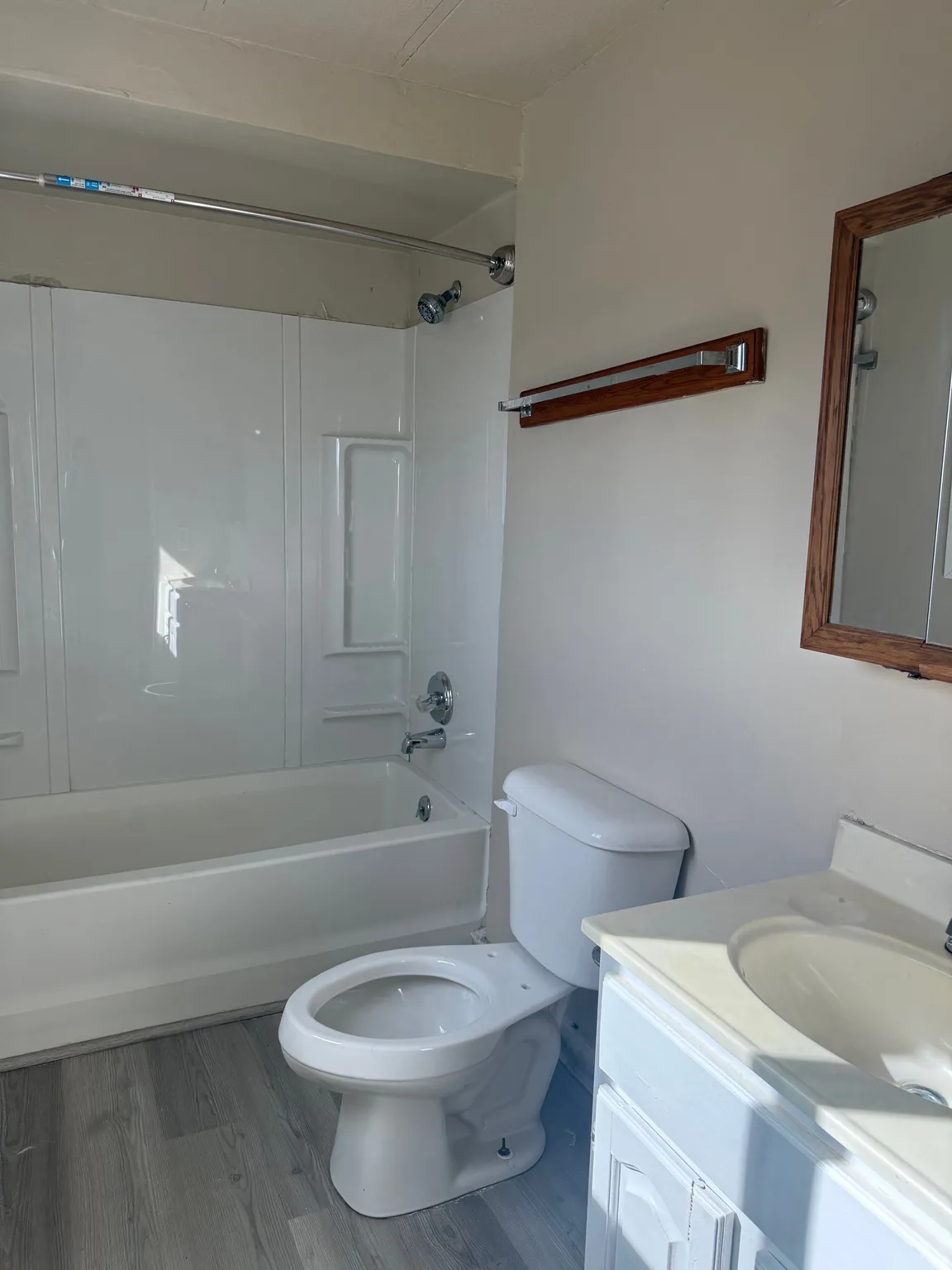 Full bathroom featuring vanity, wood finished floors, and shower / bath combination