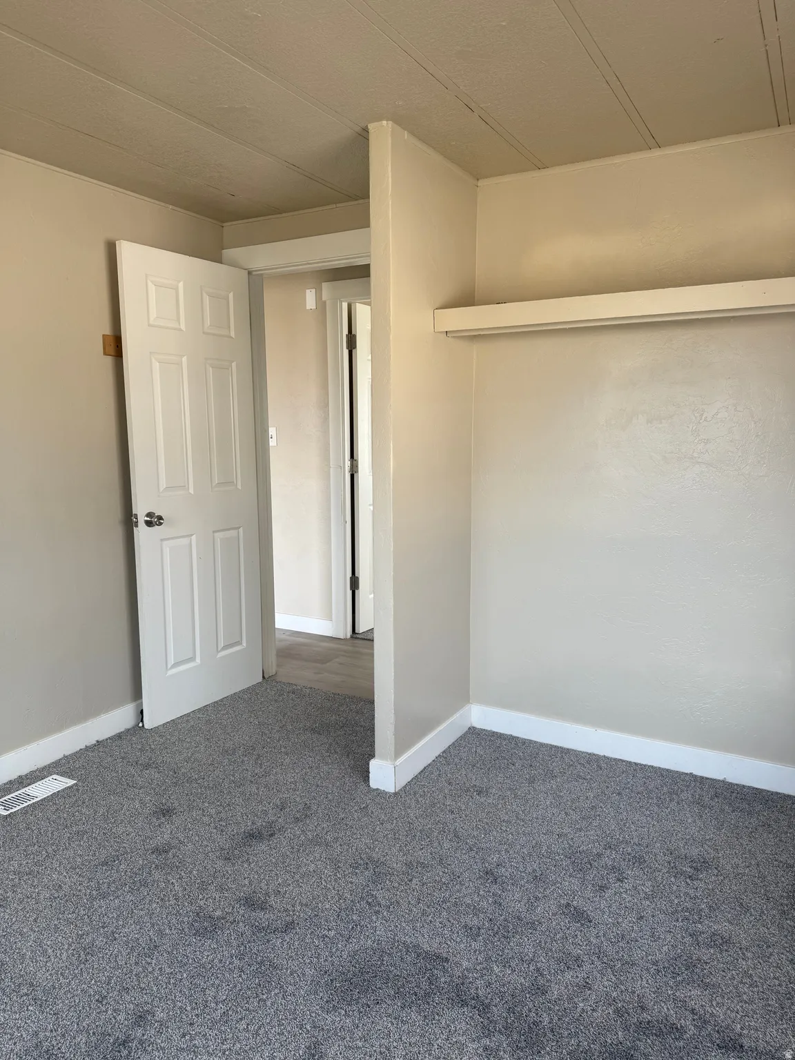 Unfurnished bedroom featuring carpet floors and baseboards