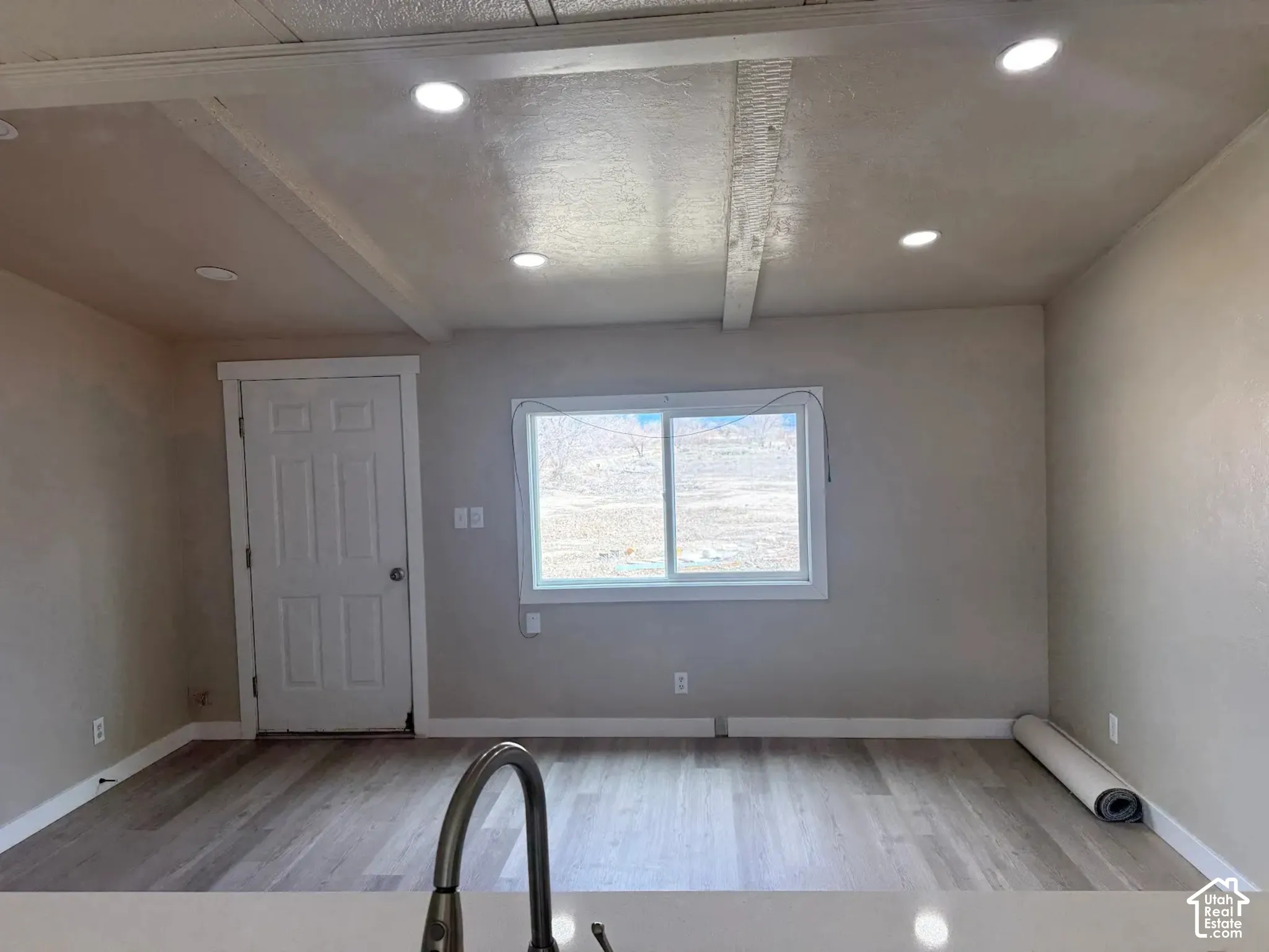Entryway featuring light wood-type flooring, beamed ceiling, and recessed lighting