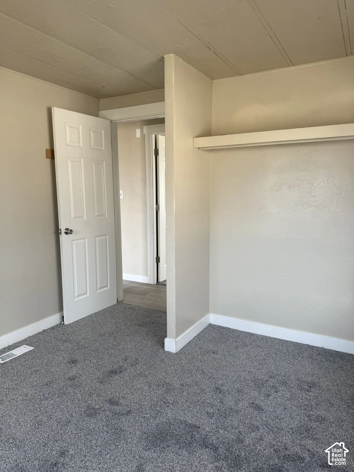 Unfurnished bedroom featuring carpet floors and baseboards