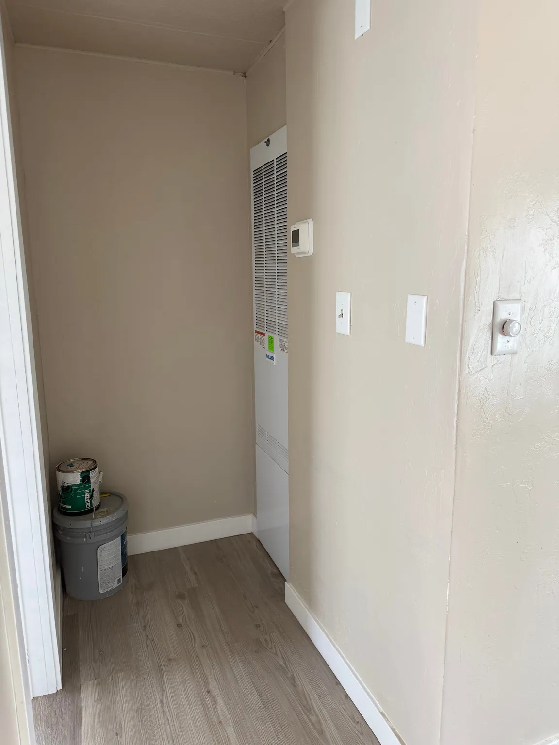 Hallway featuring light wood-style flooring and a heating unit