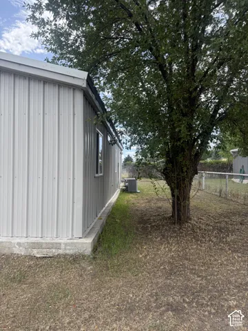 Light-colored corrugated metal siding with white trim