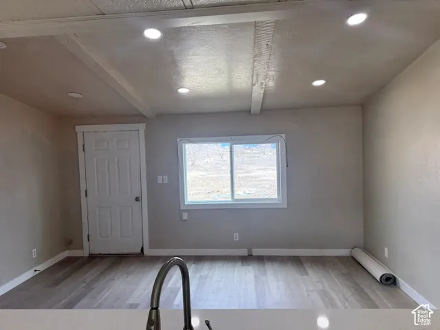 Entryway featuring light wood-type flooring, beamed ceiling, and recessed lighting