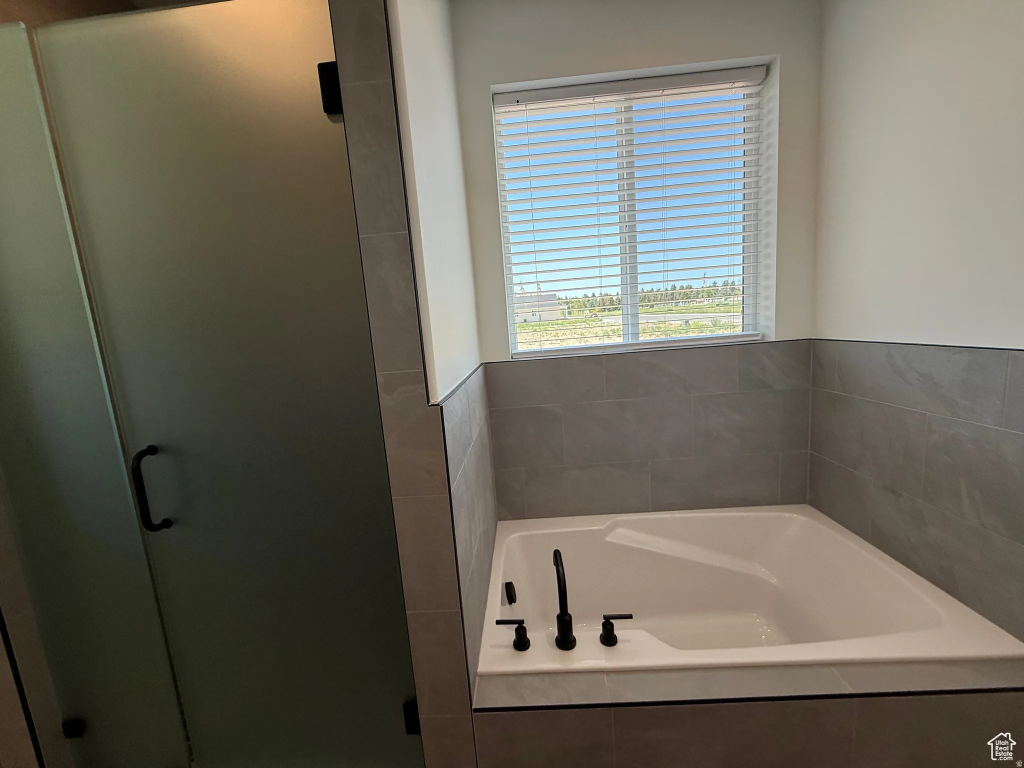 Bathroom with a stall shower and a bath