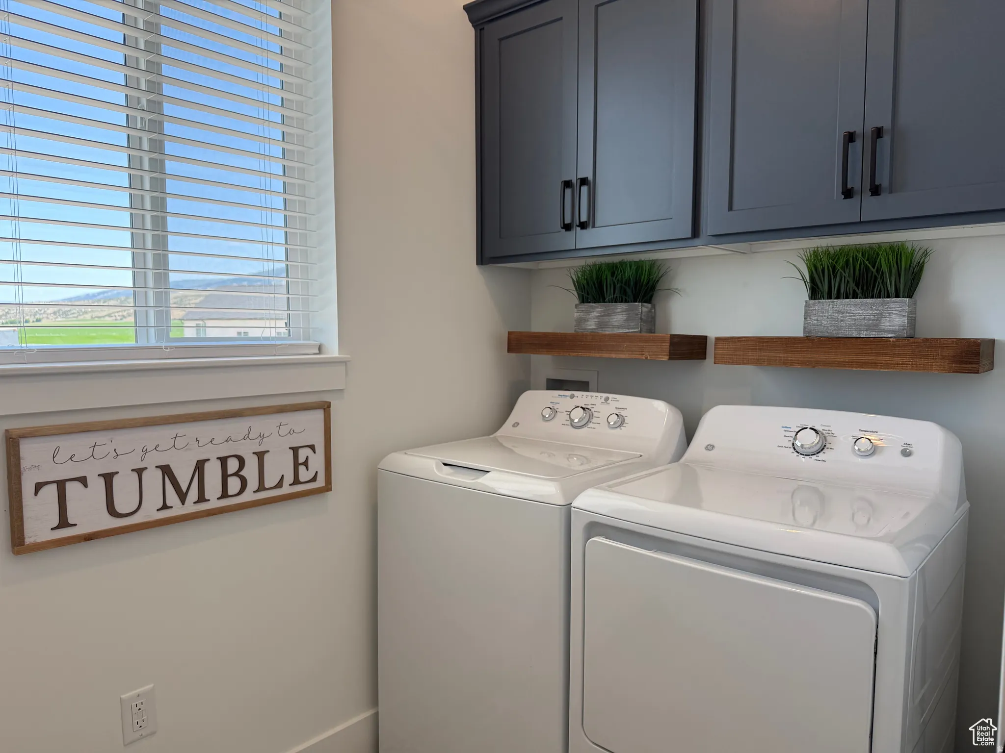 Laundry room featuring washer and dryer and cabinet space