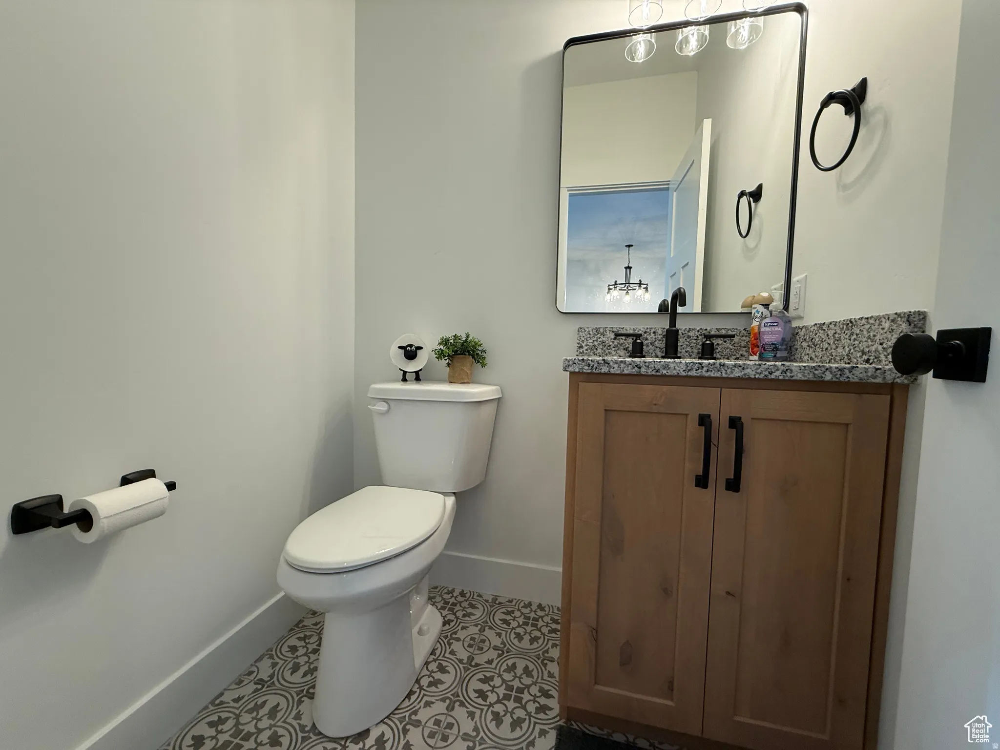 Half bath featuring vanity and light tile patterned flooring