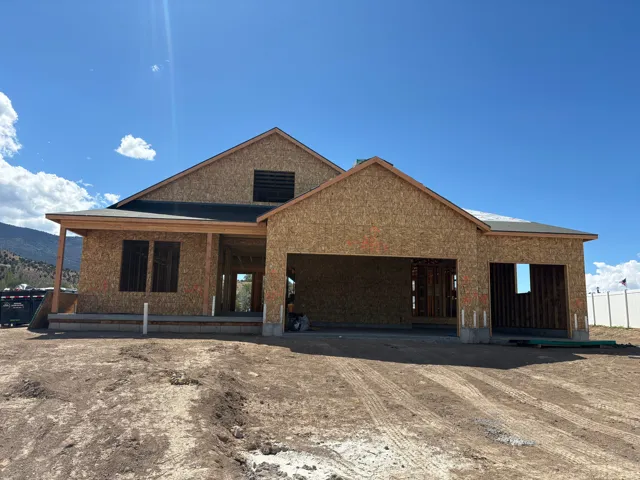Attached two-car garage, covered porch entry, and a prominent gable roofline