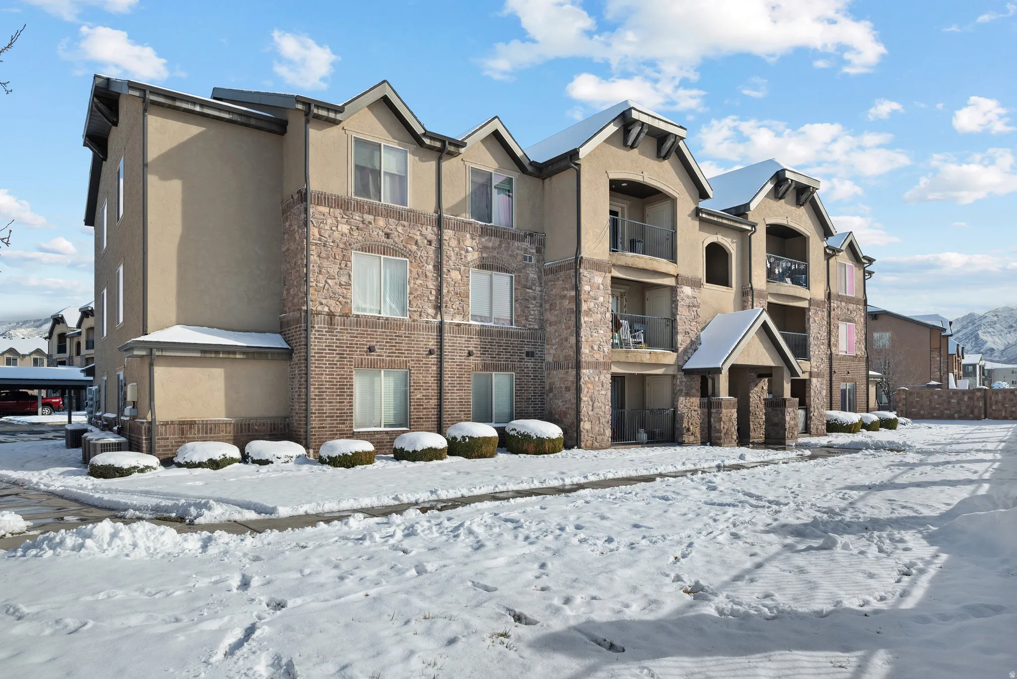 Snow covered building with a view of apartment building / complex