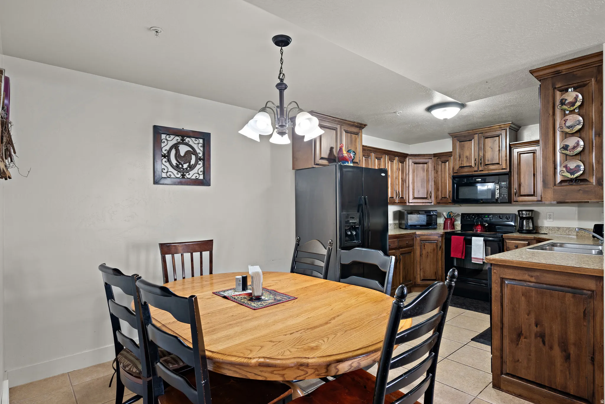 Dining room featuring hanging lights and light tile patterned floors