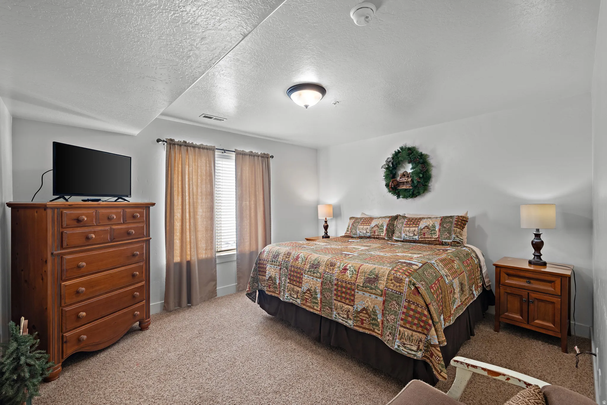 Bedroom featuring a textured ceiling and carpet flooring