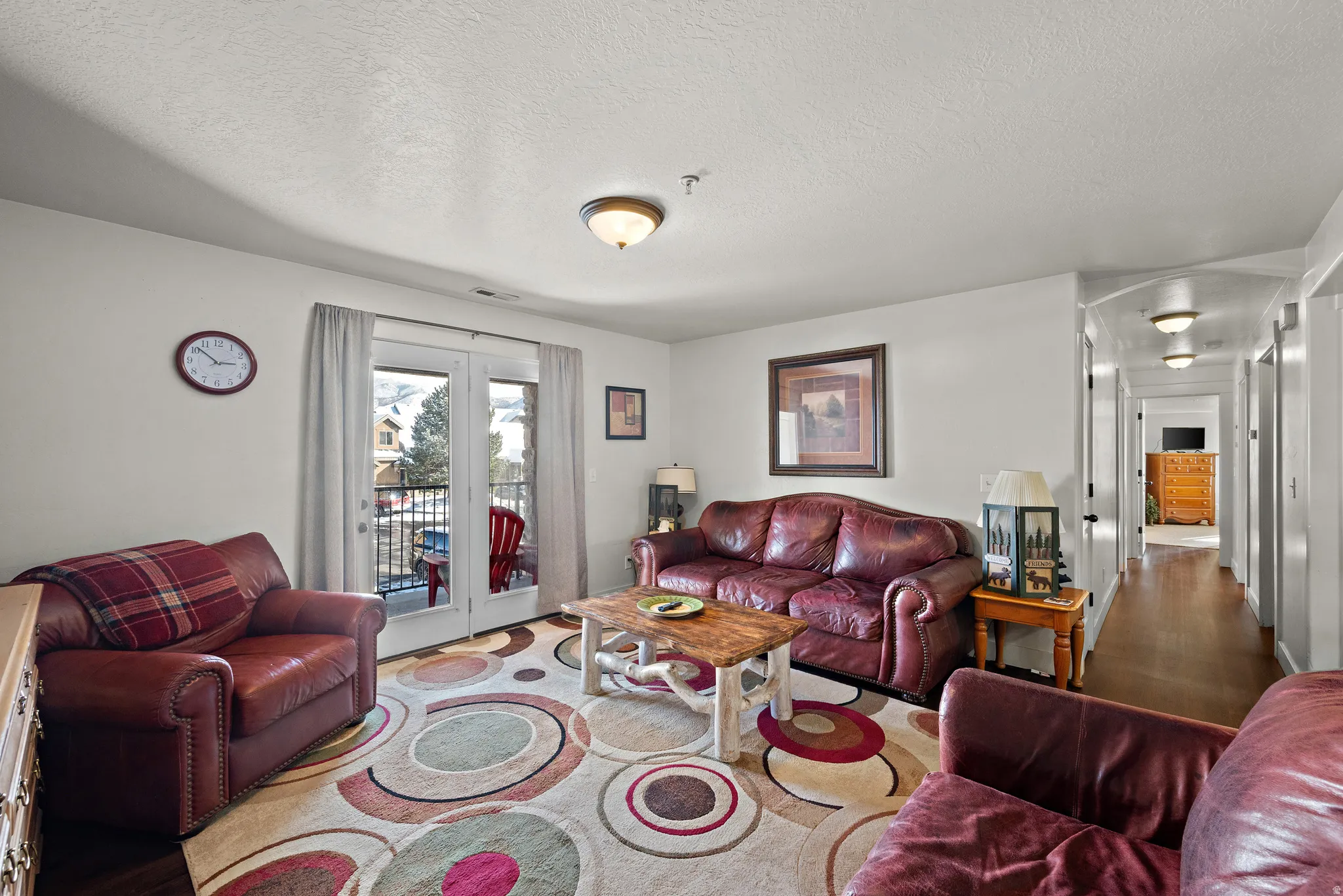 Living area featuring wood finished floors and a textured ceiling