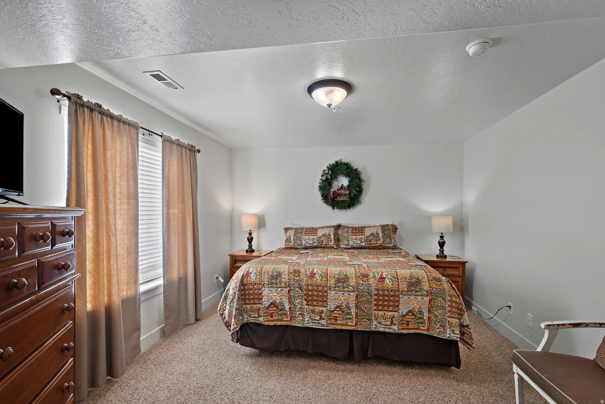 Bedroom featuring a textured ceiling and carpet floors