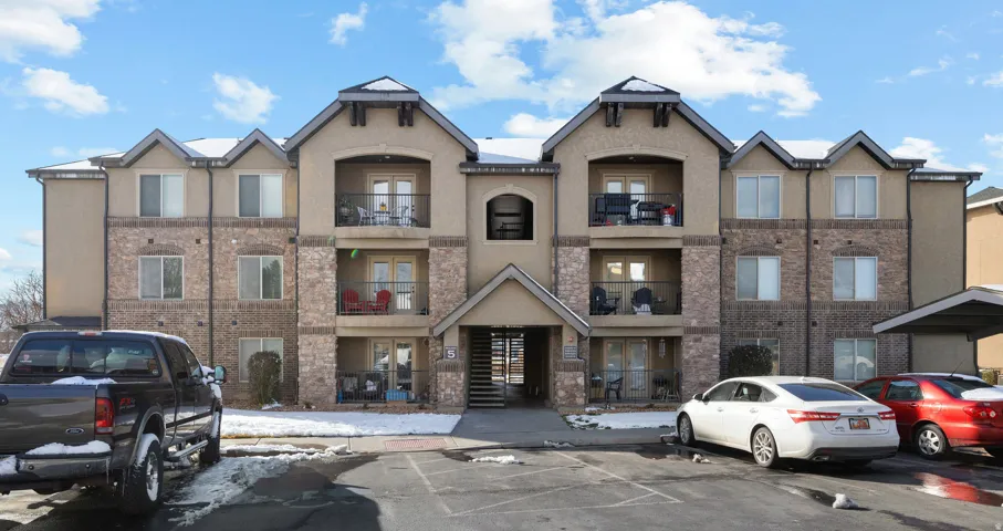 View of property with uncovered parking