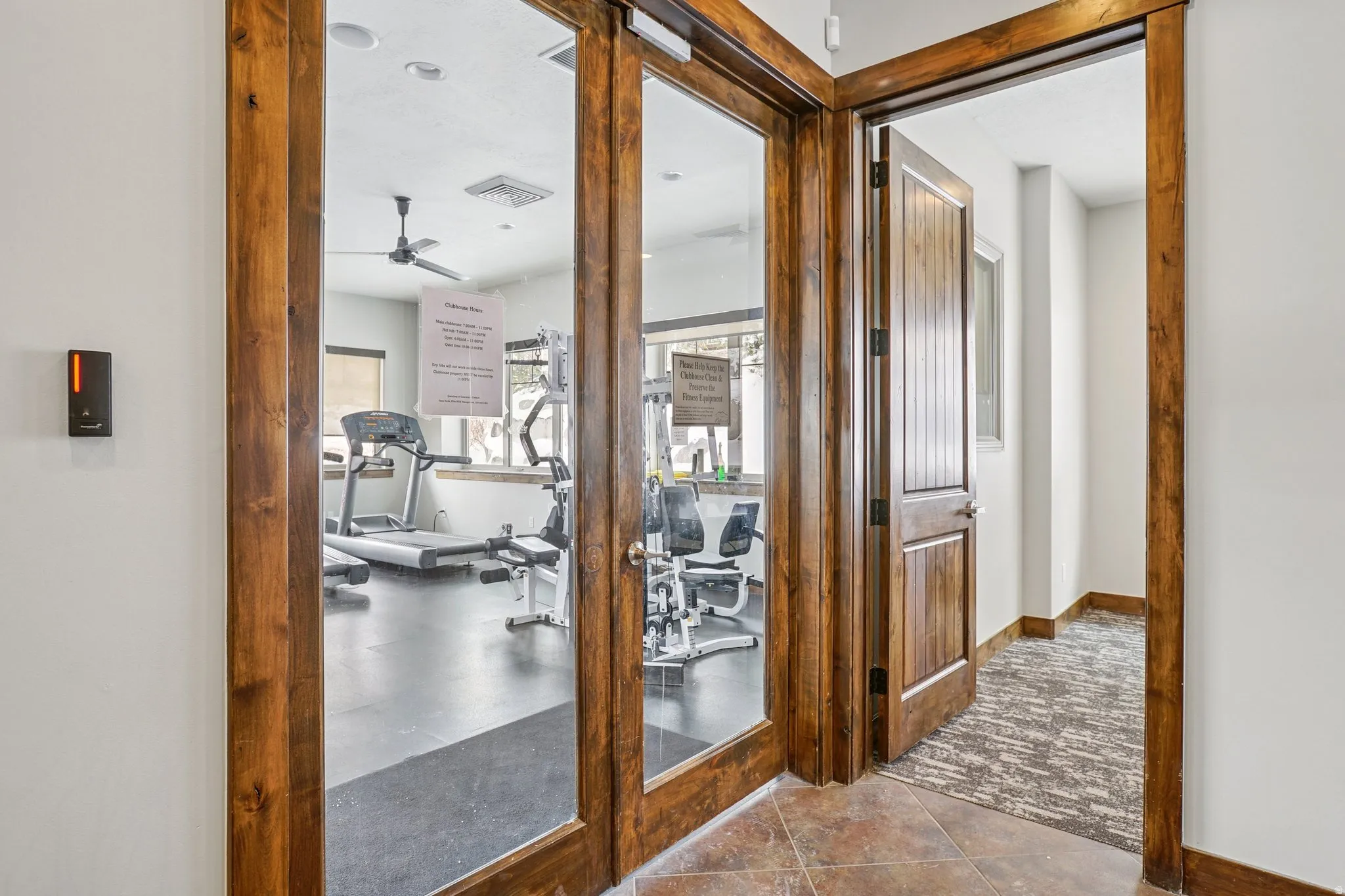 Hall with dark carpet and baseboards