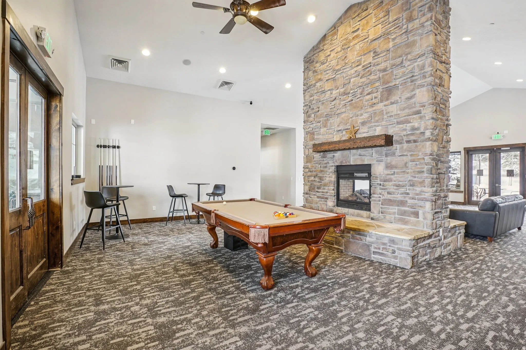 Playroom with lofted ceiling, pool table, a fireplace, ceiling fan, and recessed lighting