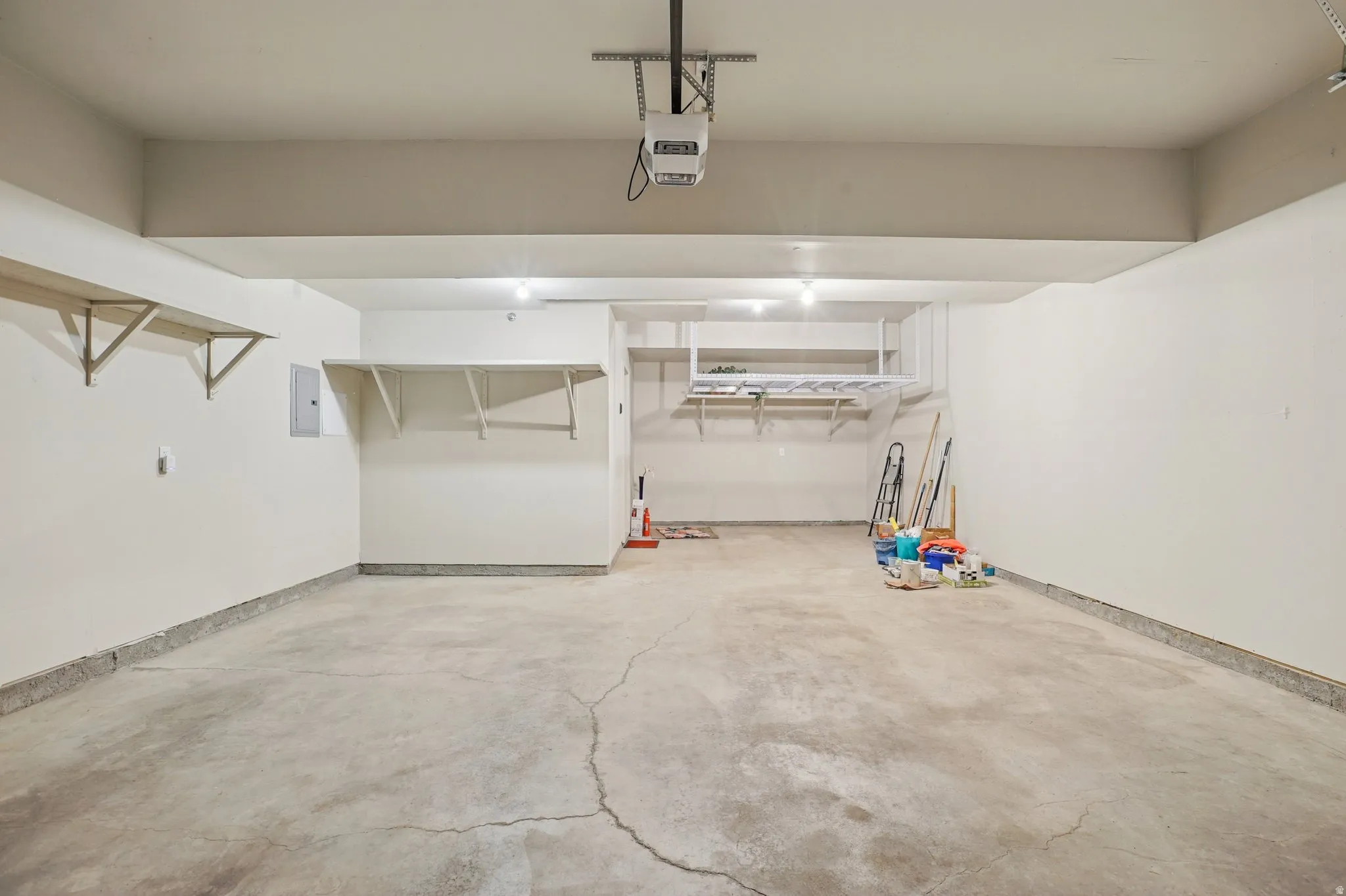Garage with electric panel and a garage door opener