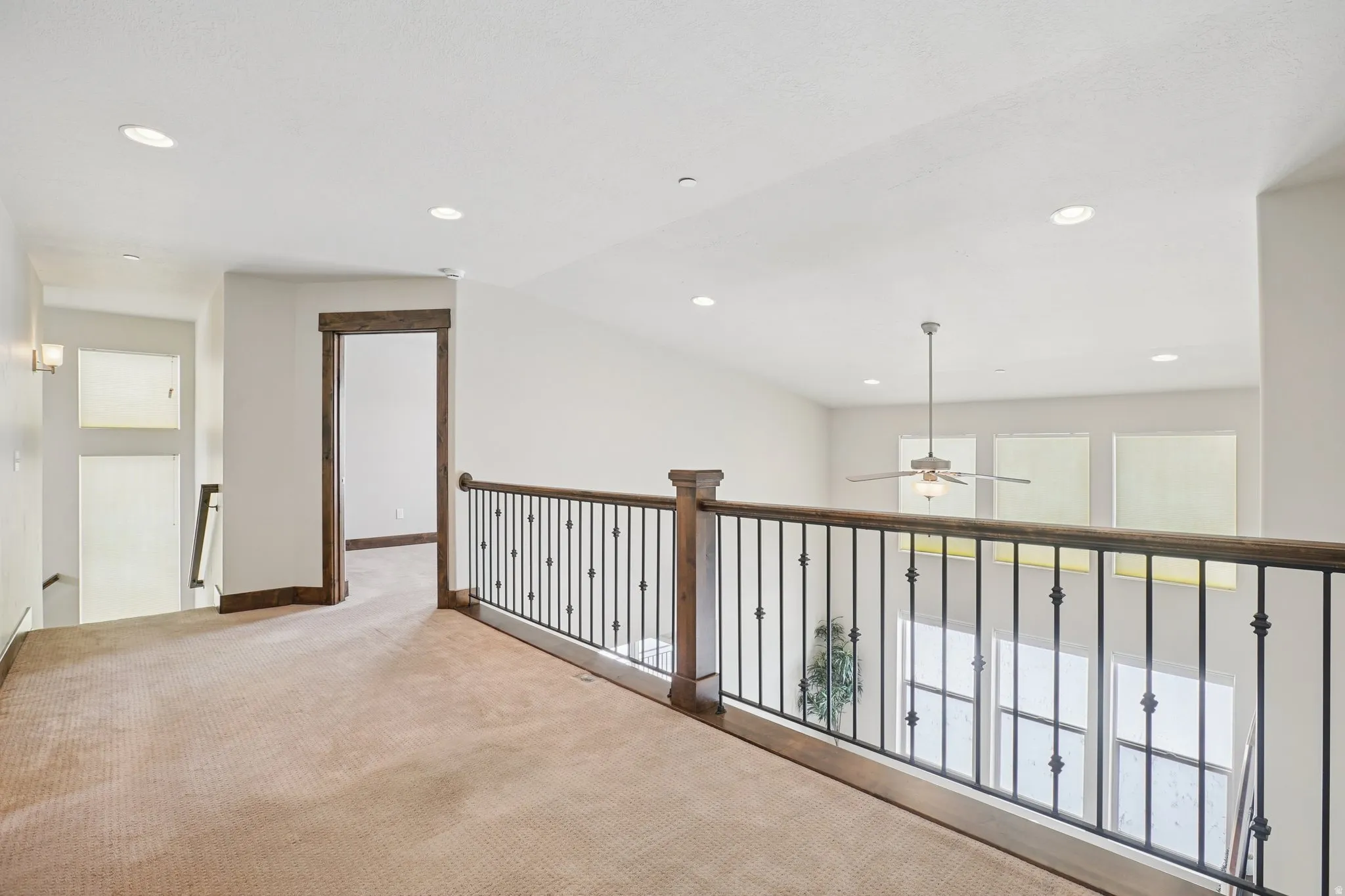 Hallway with recessed lighting, carpet floors, and vaulted ceiling