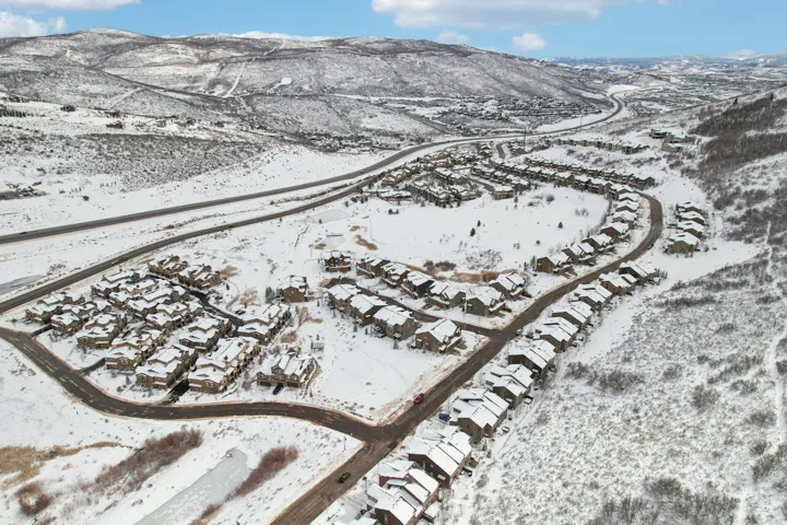 Snowy aerial view featuring a mountain view