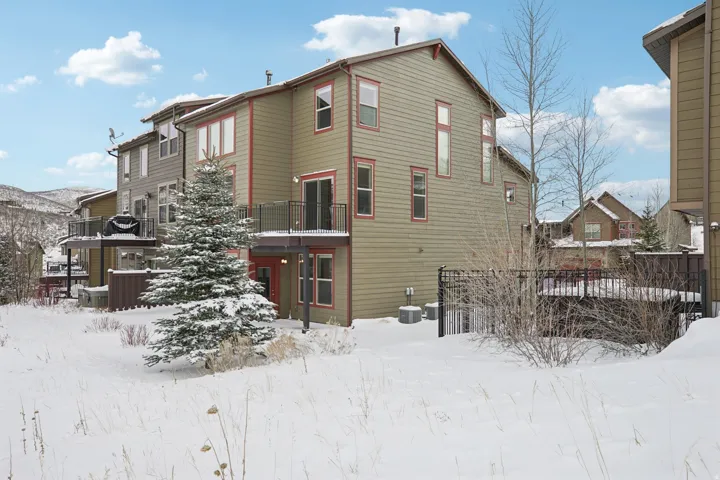 View of snow covered back of property