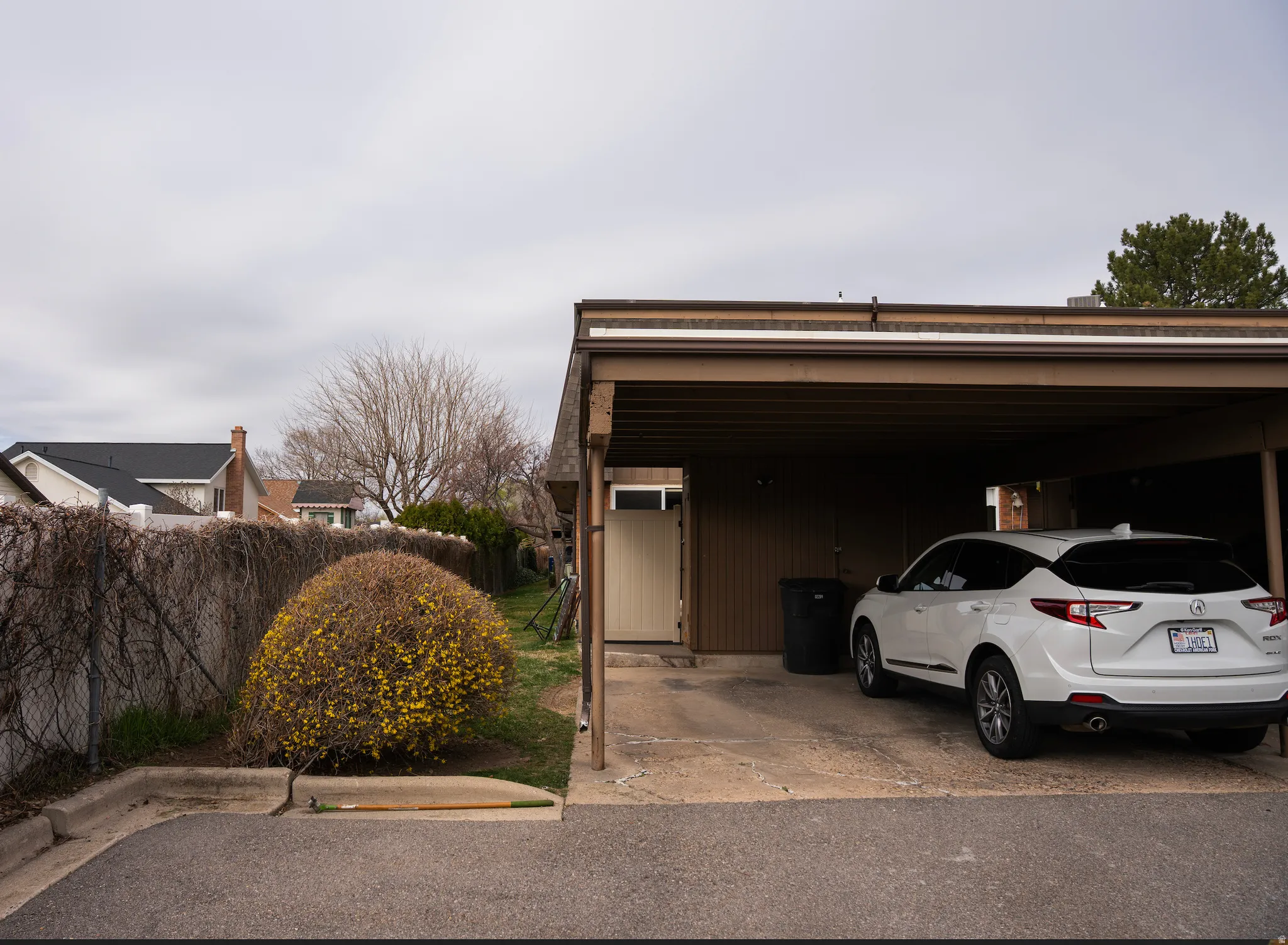 View of parking featuring a carport