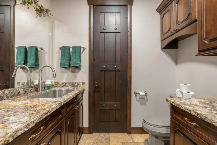 Bathroom featuring vanity, stone tile flooring, and a closet