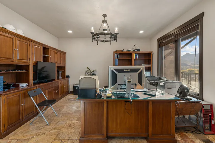 Office with stone tile flooring and hanging lights