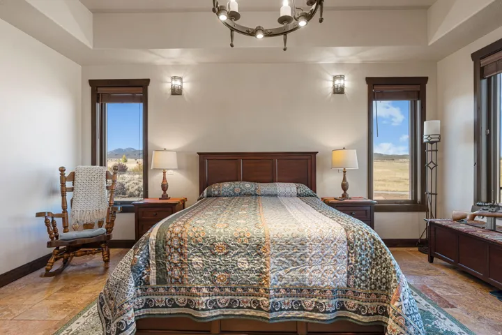 Bedroom featuring hanging lights and stone finish flooring