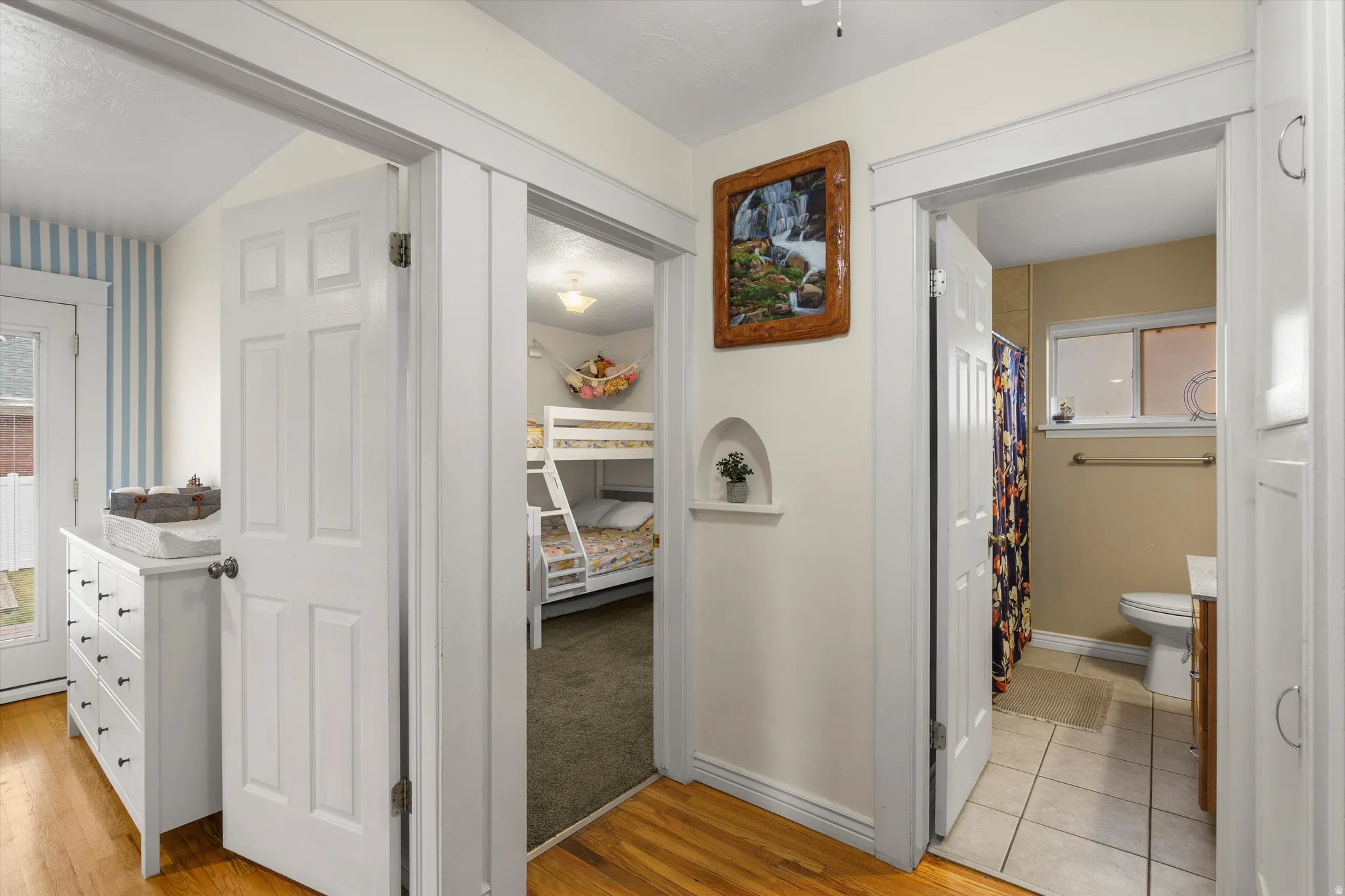 Hallway featuring light wood-style flooring and baseboards