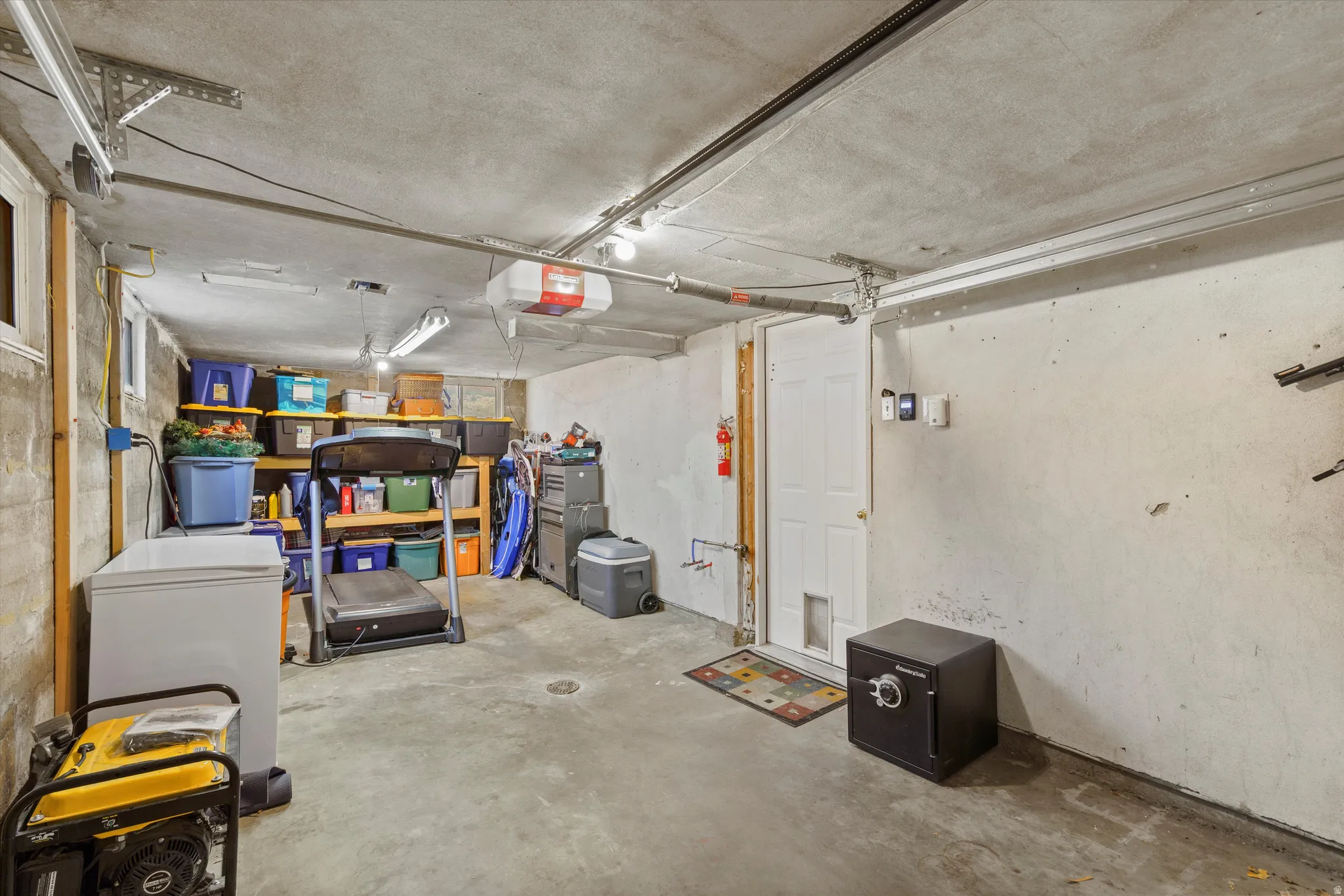 Basement featuring a garage and white refrigerator