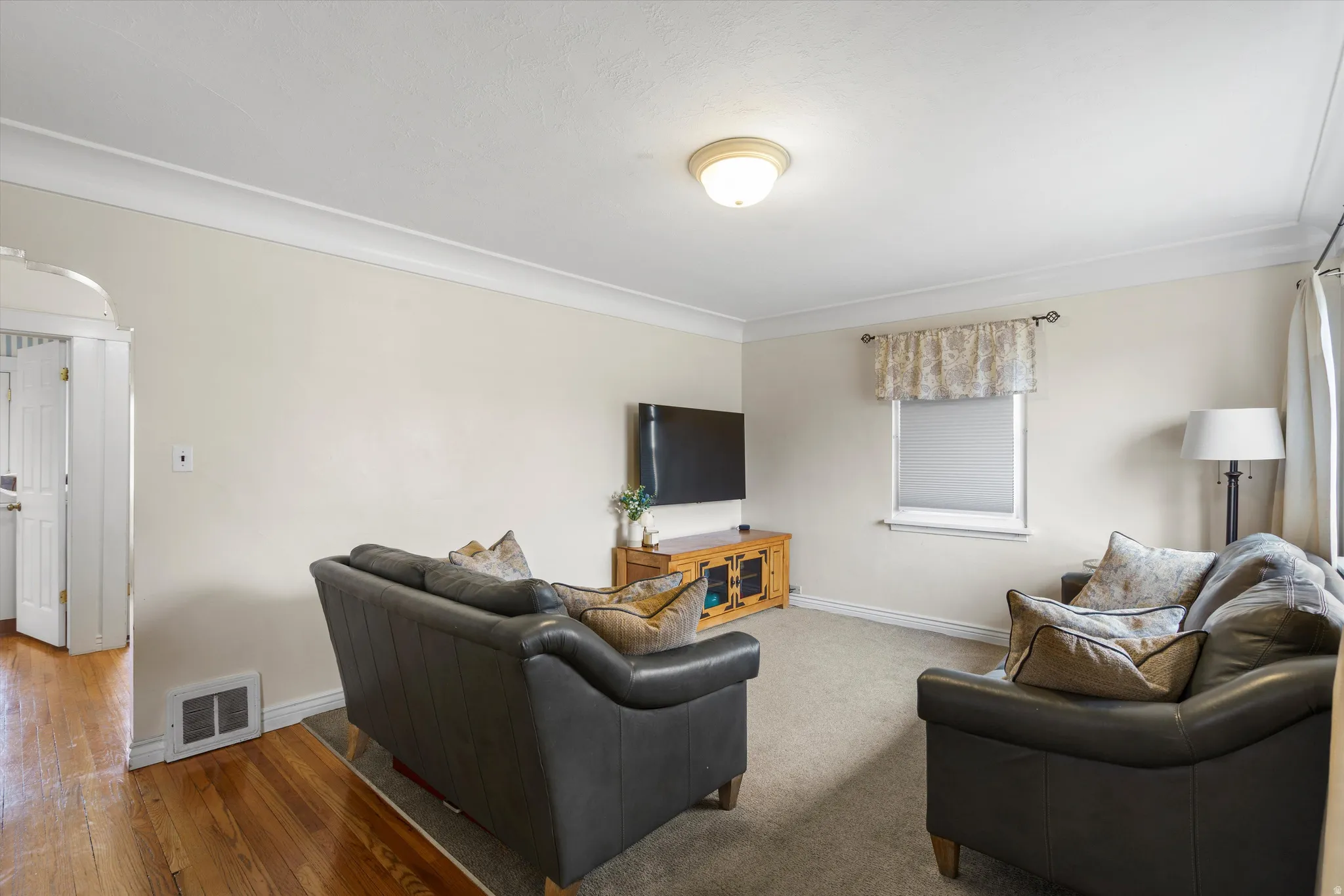 Living area featuring baseboards and wood-type flooring