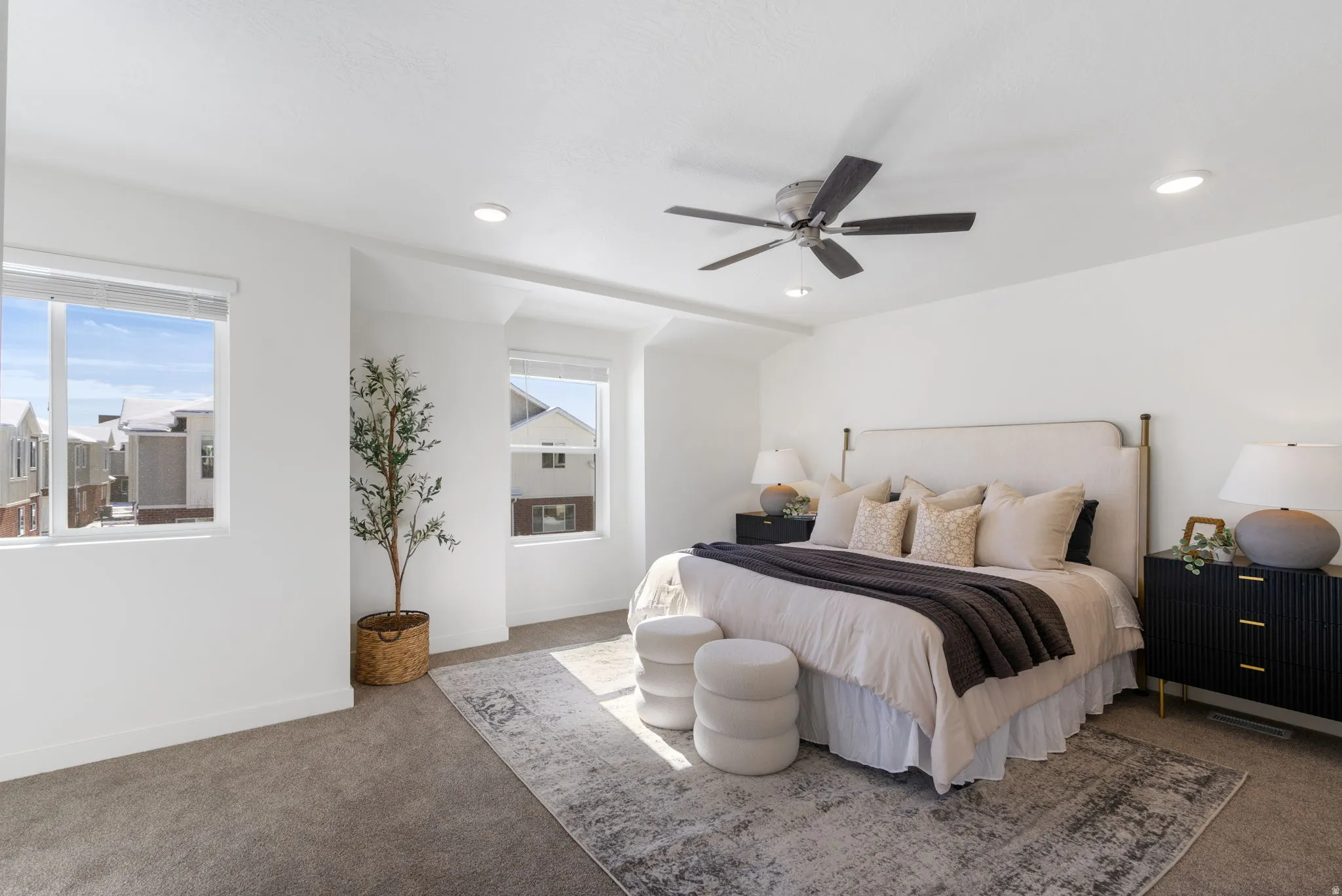 Carpeted bedroom featuring a ceiling fan and recessed lighting