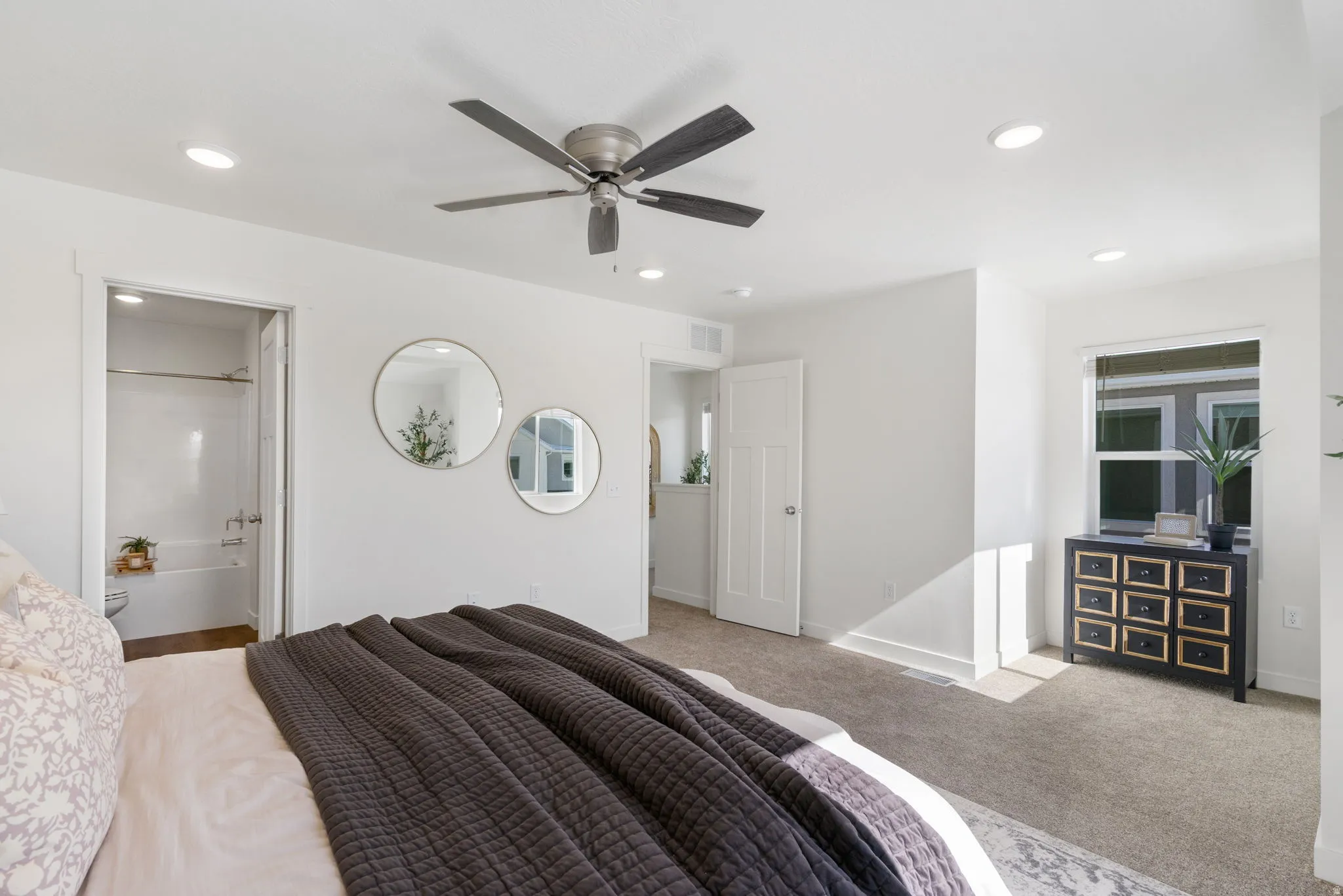 Carpeted bedroom with a ceiling fan, recessed lighting, and ensuite bath