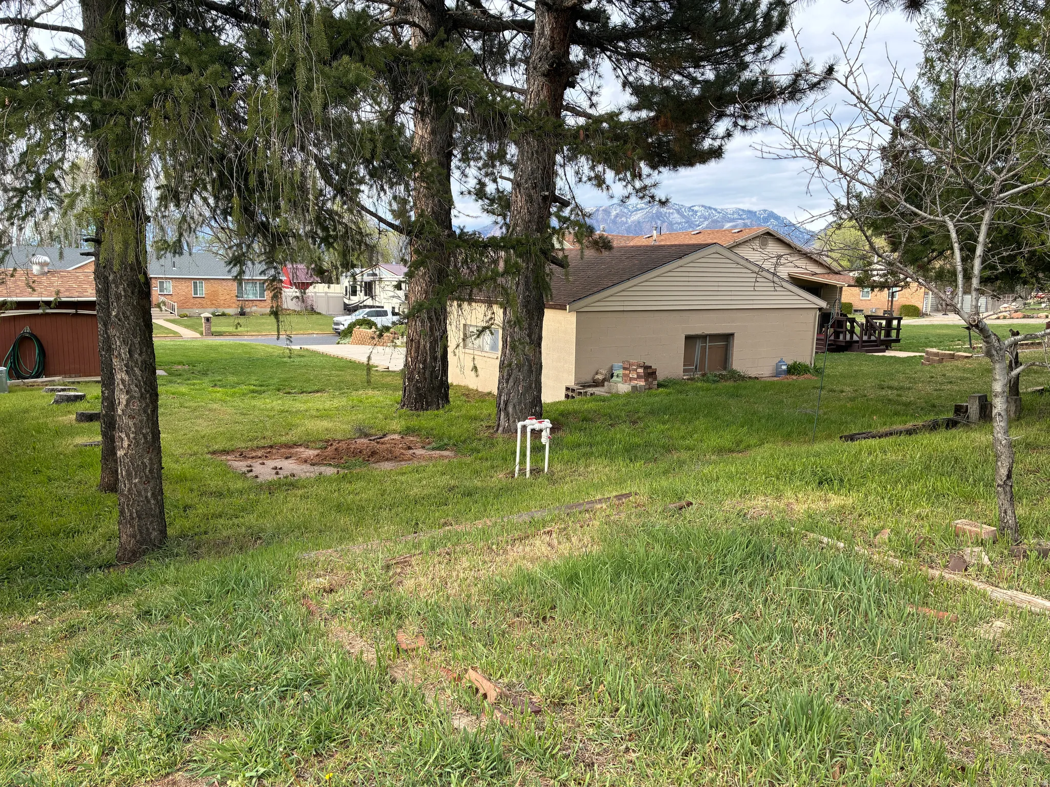 On the opposite side of the garage the lot extends out another 30 feet or so, there is a cement slab where you could store an RV, a side by side, 4-wheelers, or any of your toys. There are garden plots ready to go bordered with railraod ties.