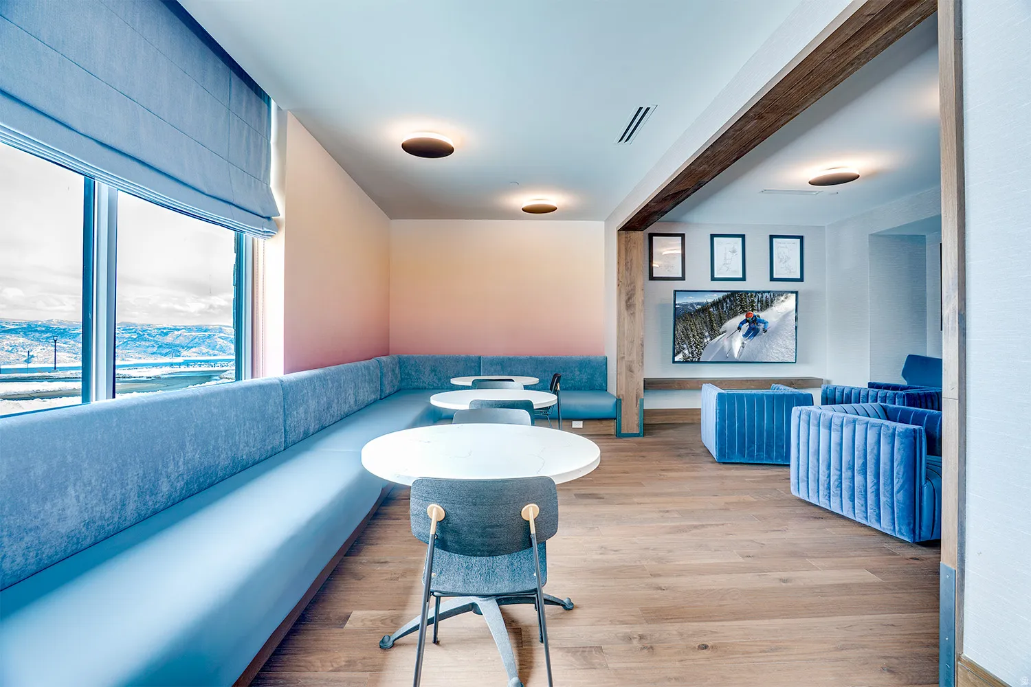 Living area featuring light wood-style floors and beamed ceiling