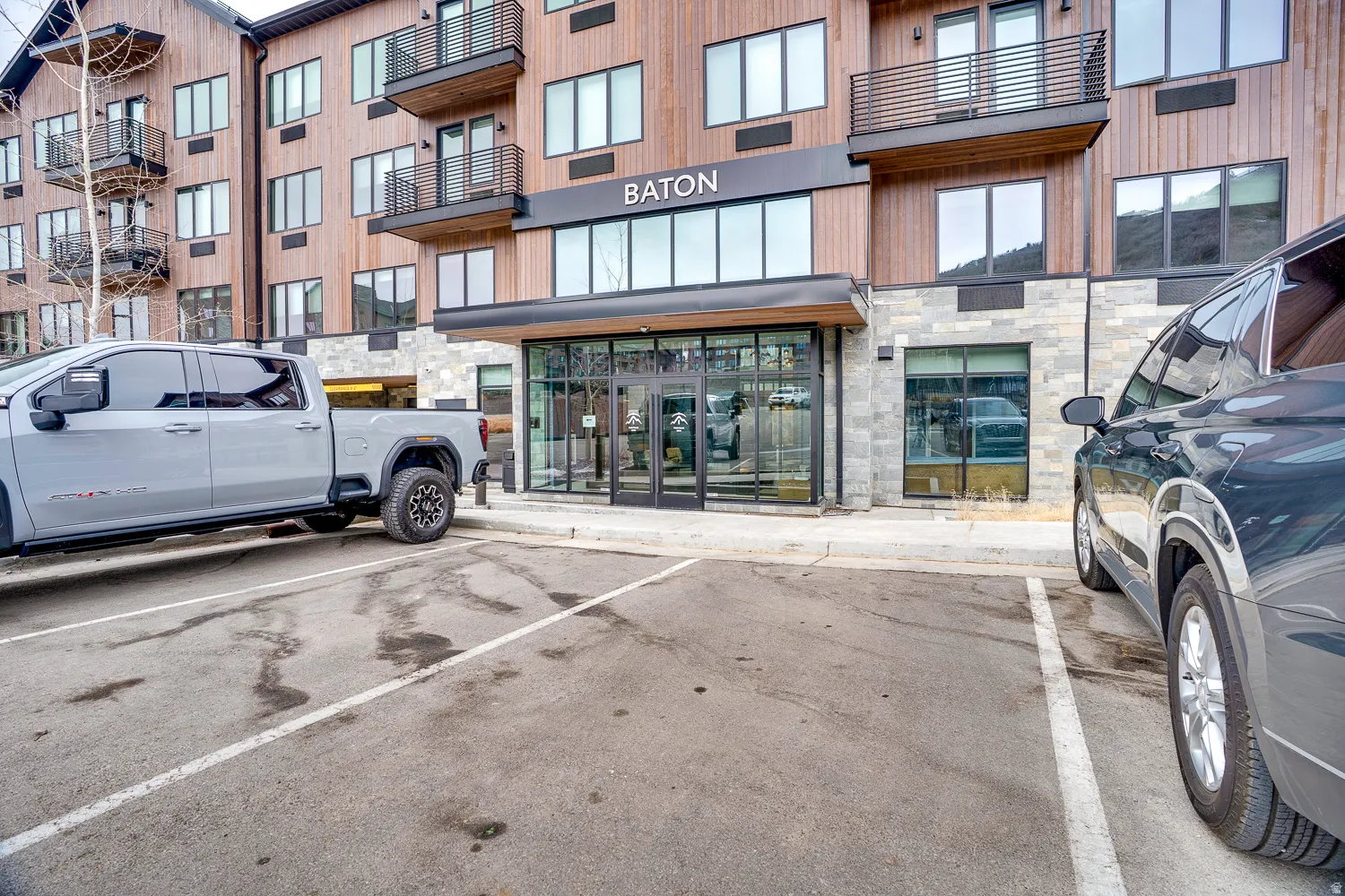 View of property featuring uncovered parking