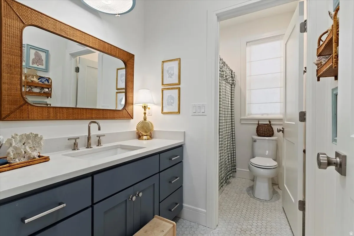 Full bathroom featuring vanity, a shower with shower curtain, and light tile patterned flooring
