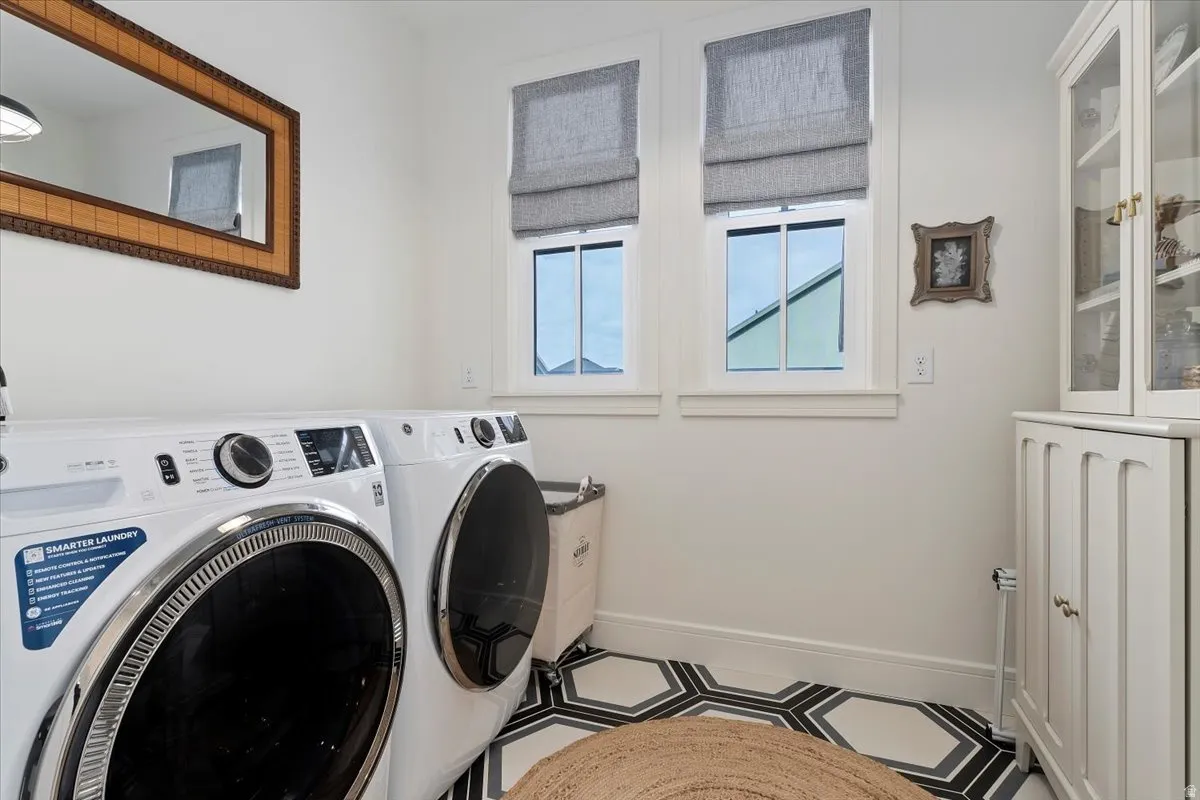 Laundry room with baseboards and washer and clothes dryer