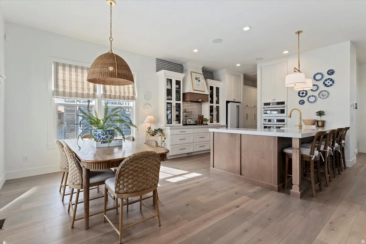 Dining area featuring light wood-type flooring and recessed lighting