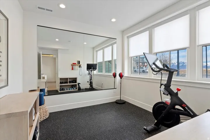 Workout area featuring recessed lighting and dark rubber floors