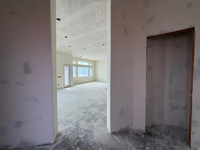 Recessed ceiling lighting, large windows, and a glass-paneled door