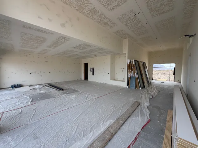 Open-concept interior with high ceilings and a wide doorway