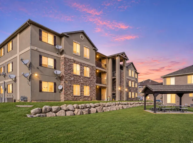Multi-story building featuring stone and stucco exterior