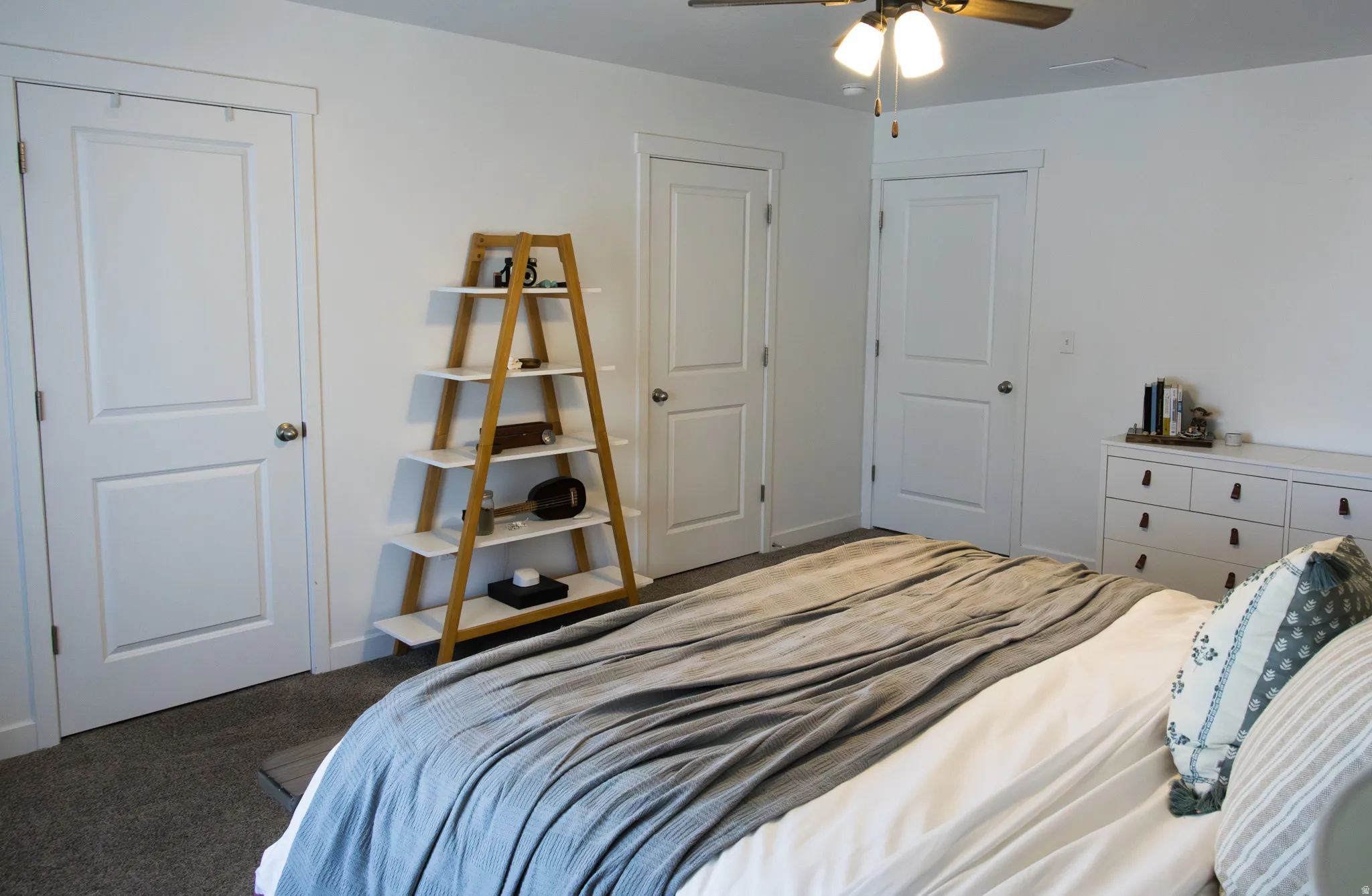 Bedroom featuring dark carpet and ceiling fan