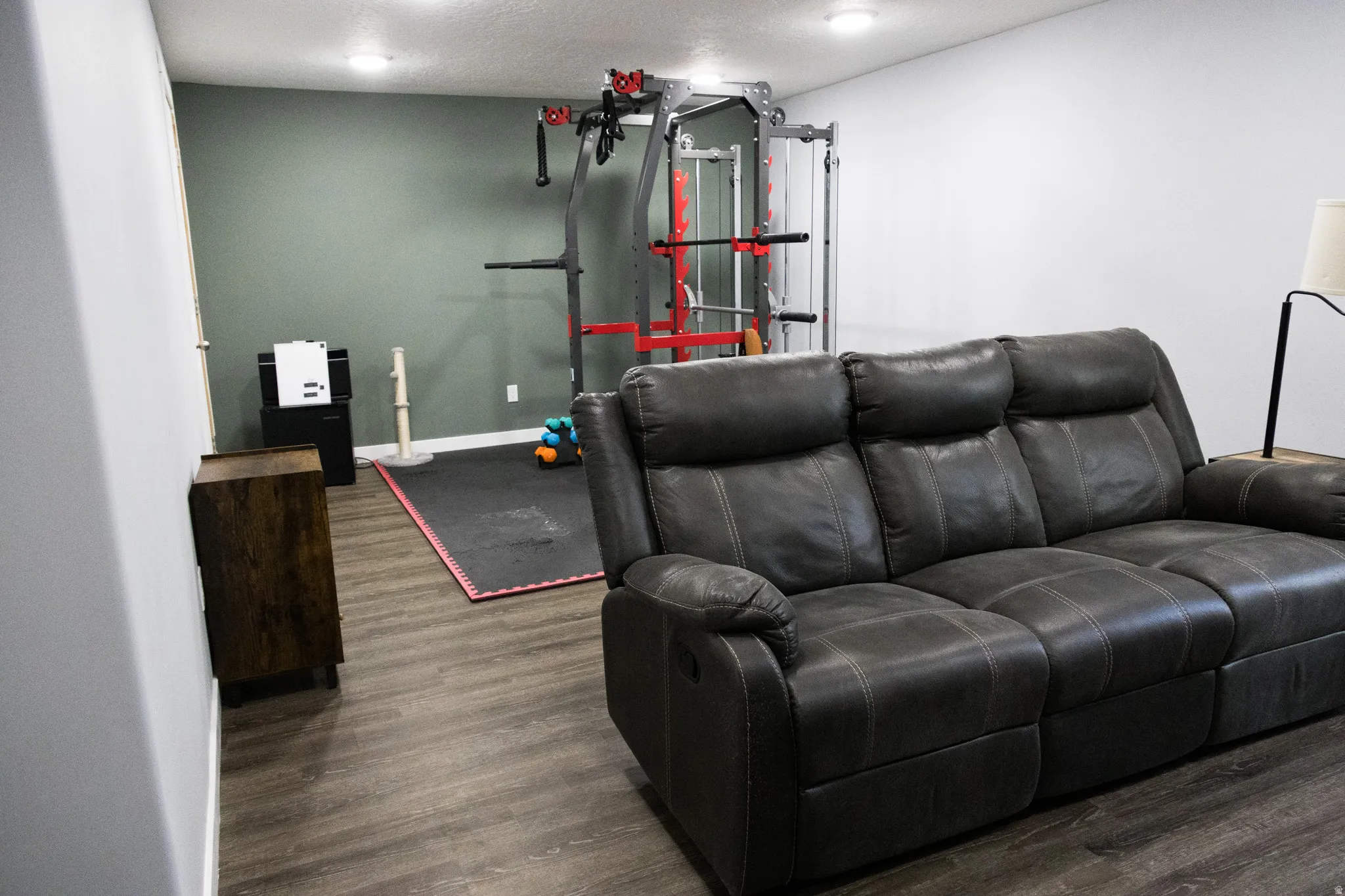 Home theater featuring dark wood-type flooring and a textured ceiling