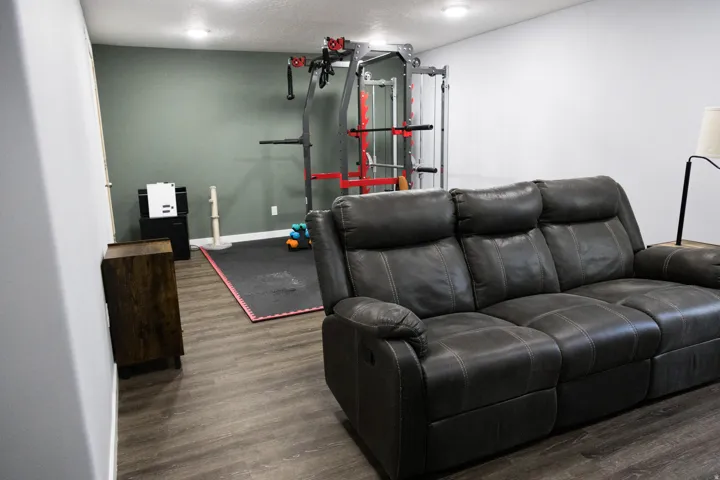 Home theater featuring dark wood-type flooring and a textured ceiling