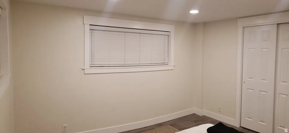 Unfurnished bedroom with a closet, recessed lighting, and dark wood-style floors
