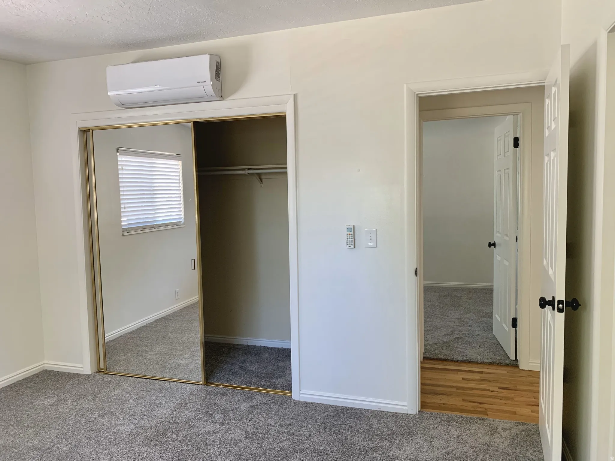 Unfurnished bedroom featuring carpet, a closet, and a textured ceiling