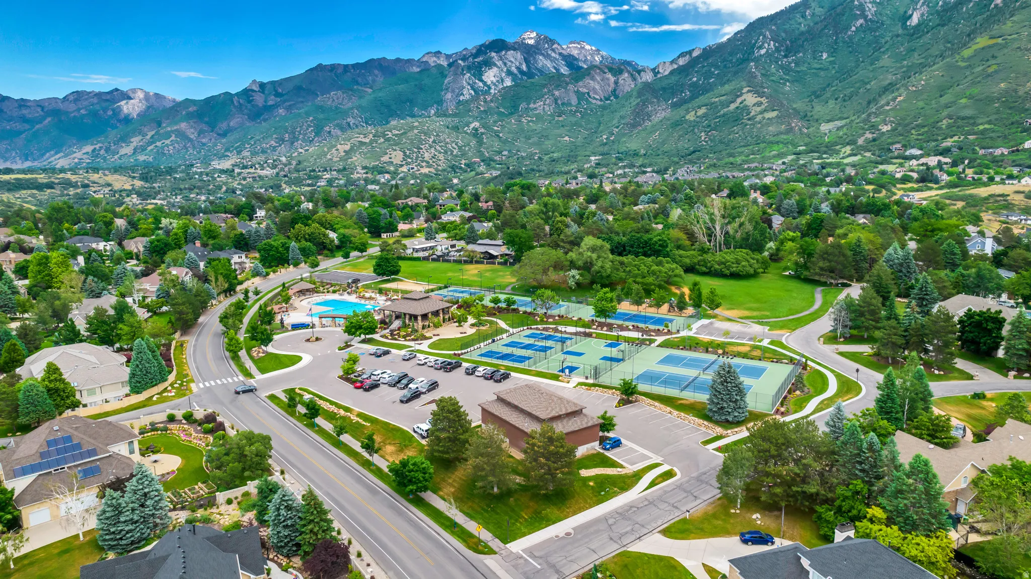 Aerial view of property's location with a mountainous background and nearby suburban area