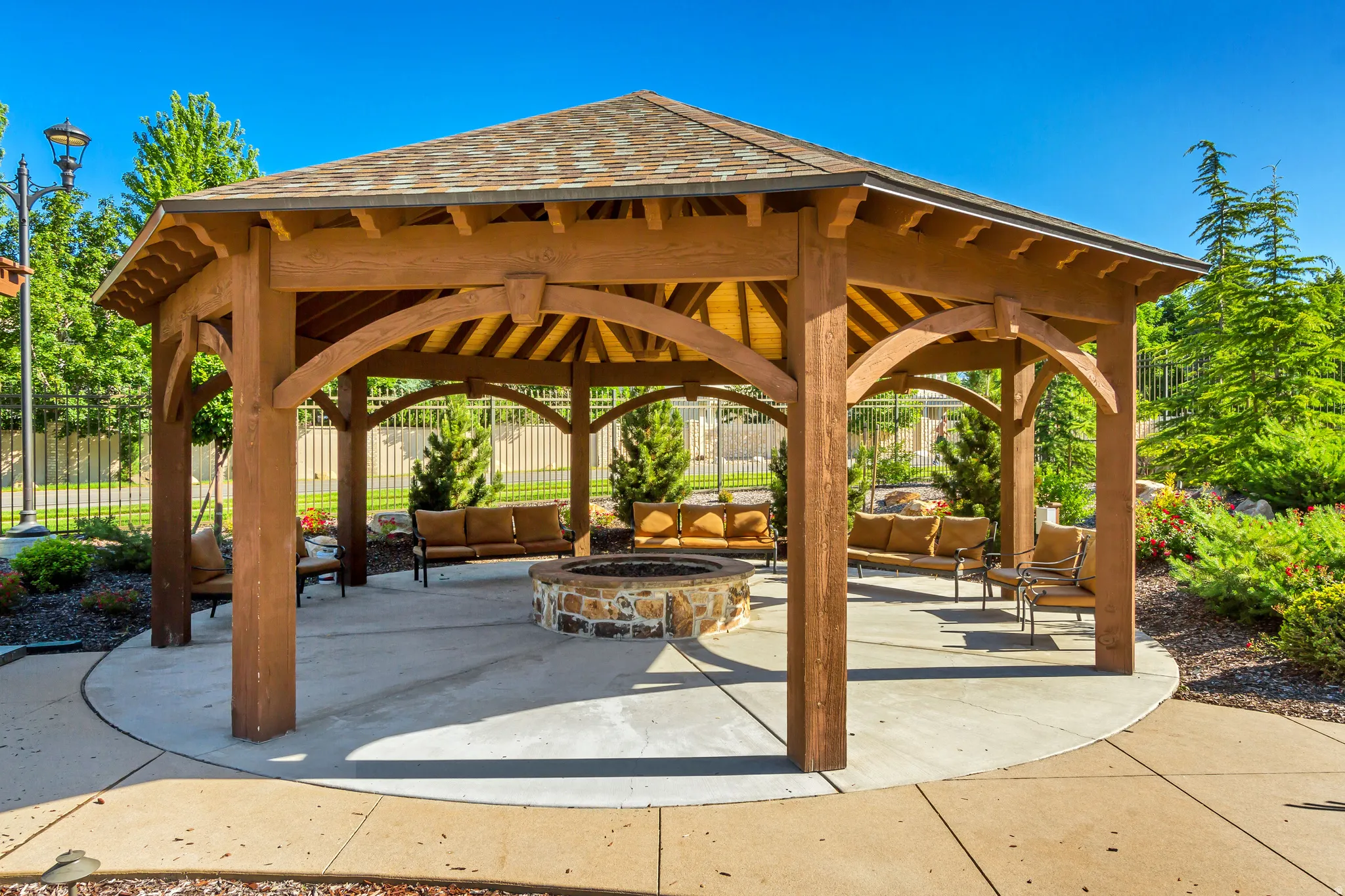 View of community featuring a patio and an outdoor living space with a fire pit