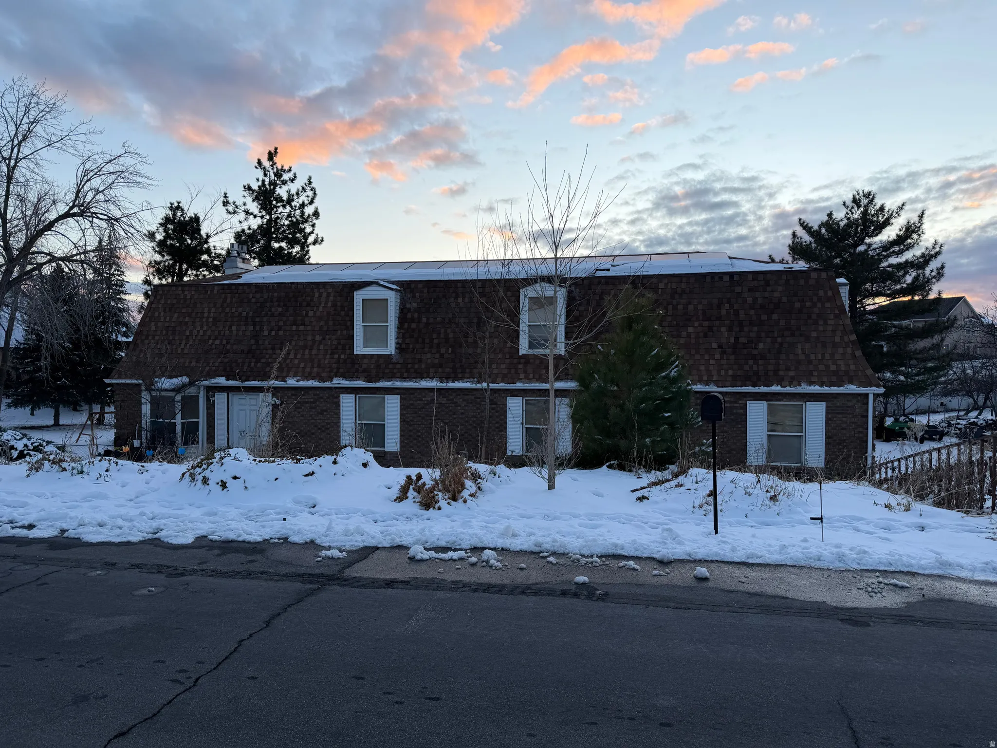 Colonial inspired home with brick siding